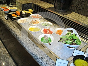 Fresh of salad bar with variation of dressing and cheese display