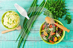 Fresh salad and bowl of mashed potatoes.