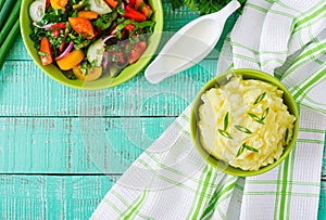 Fresh salad and bowl of mashed potatoes.