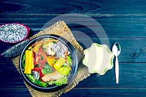 Fresh salad with chicken, tomatoes and mixed greens,corn salad, arugula, mesclun, mache