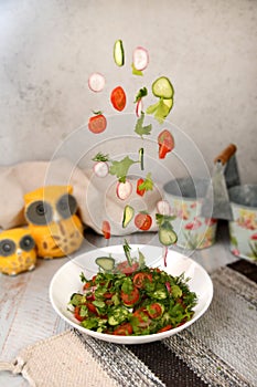 Fresh salad flying in a plate