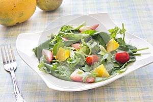 Fresh salad with fruits vegetables and greens