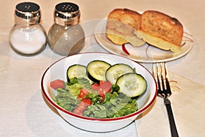 Fresh Salad with Garlic Toast on White Table