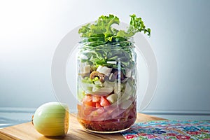 Fresh salad in a glass jar.