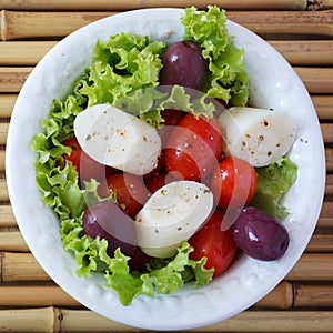 Fresh salad of heart of palm (palmito), cherry tomatos, olives
