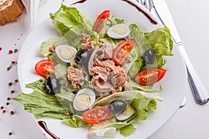 Fresh salad with iceberg lettuce,tomatoes,eggs,canned tuna and olives