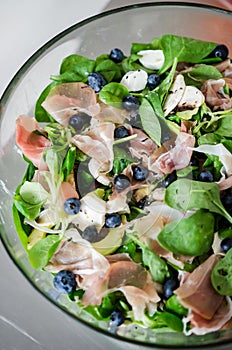 Fresh salad with lamb lettuce, avocado and prosciutto