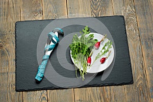 Fresh salad and measuring tape on wooden background