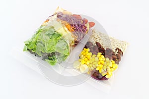 Fresh Salad packed in plastic bag on white background - Fast healthy food concept