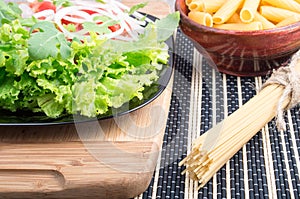 Fresh salad on a plate, and pasta