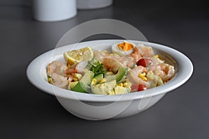 Fresh salad with prawns, egg and lemon. Full of vitamins with fruits and vegetables. Cucumber, quinoa, tomato