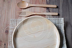 Fresh salad in wooden plate on wood table