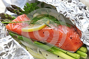 Fresh salmon with asparagus in foil photo