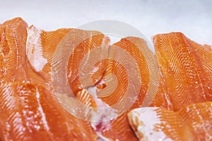 Fresh Salmon Fillets on Ice close up, top view