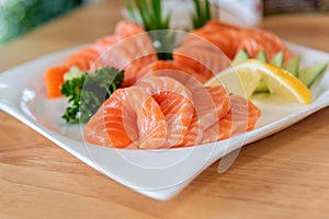Fresh salmon sashimi sliced in white dish