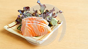 Fresh salmon sashimi on a wooden table