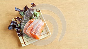 Fresh salmon sashimi on a wooden table