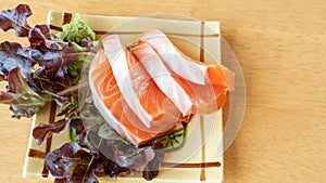 Fresh salmon sashimi on a wooden table