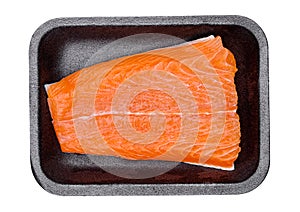 Fresh salmon slice meat in black tray isolated