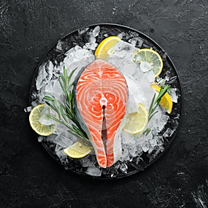 Fresh salmon steak on ice. Top view.