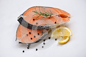 Fresh salmon steak on white plate  background - Raw salmon fish fillet for cooked steak seafood with herbs and spices lemon