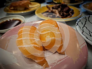 Fresh salmon sushi on a plate, ready to serve those who like to eat Japanese-style food.