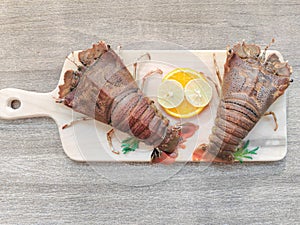 Fresh Sand Lobster or Flathead Lobster or Slipper Lobster decorated with herbs and vegetables .Selective focus photo