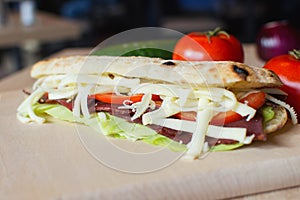 Fresh sandwich on a wooden chopping board