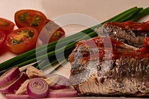 Fresh sardines with tomato sauce and other vegetables