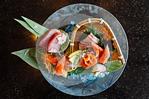 Fresh sashimi set including Blue Fin Tuna, Hamachi, Crab stick served with wasabi and sliced lemon