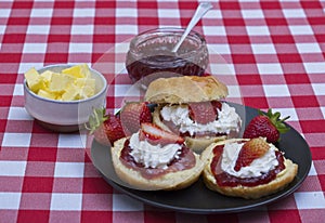 Fresh scones topped with strawberry jam,whipped cream