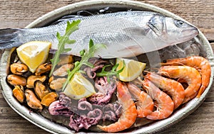 Fresh seabass with seafood on the tray