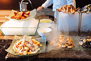 Fresh Seafood buffet line including Alaska king crab, Shrimp, Lobster, Oyster and Perna viridis