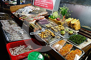 Fresh, Seafood, Filled, Salt-fish, Bread, Green Peppers, Vegetables Set for Sale displayed On the Counter, Street Market on Night