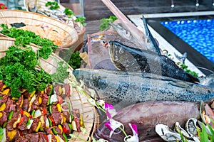 Fresh seafood on ice at luxury outdoor buffet next to swimming pool