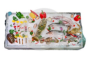 Fresh seafood mixed with various kinds of sea animals, including fish, shrimp, shellfish, arranged on ice and decorated with Vario