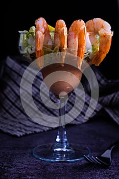 Fresh seafood Prawn cocktail served in a tropical restaurant in a margarita glass with decoration of prawn on the corner with