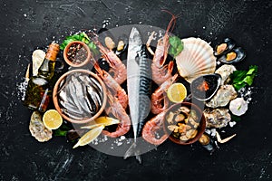 Fresh seafood on a stone background. Fish, shrimp, mussels, caviar.