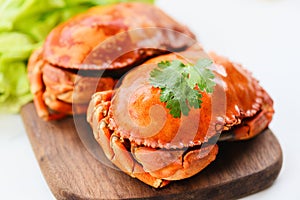 Fresh seafood stone crab - Crab cooked steam or boiled with salad vegetable on wooden board on white background