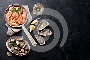 Fresh seafood and white wine. Scallops, oysters and shrimps photo