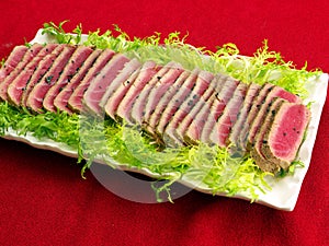 Fresh Seared tuna fish slices on tray photo