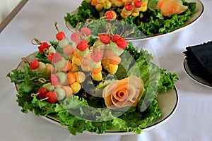 Fresh seasonal fruit skewers on bed of lettuce