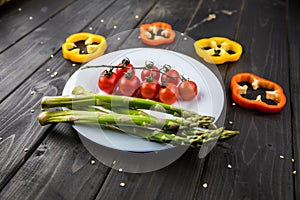 Fresh seasonal vegetables on plate on wooden table background
