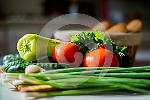 Fresh seasonal vegetables on wooden board on table.