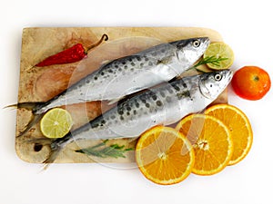 Fresh Seer Fish,King Fish decorated with herbs and vegetables on a wooden pad,Selective Focus