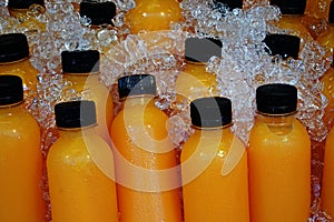 Fresh selfmade orange juice withcold ice in half litres bottles
