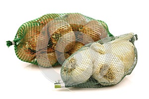 Fresh shallots and garlic in green plastic nets