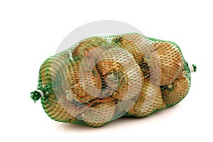 Fresh shallots in a green plastic net