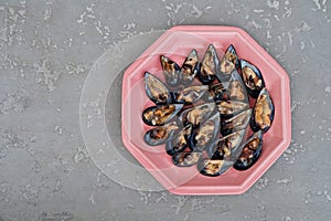 Fresh shellfish on pink plate