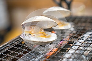 Fresh shells are grilled on mini strove, in local Japanese restaurant